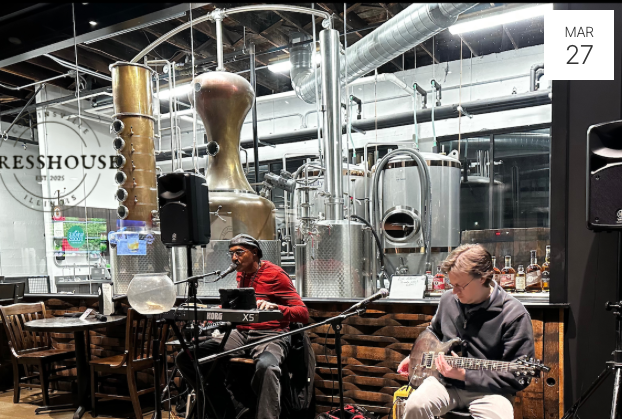 Brian Foggs performing music in front of distilling tanks at PRessHouse in Uptown Collinsville